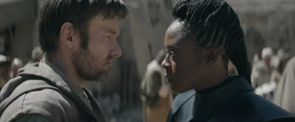 A scene from the Star Wars movie with Obi-Wan and a black woman facing each other