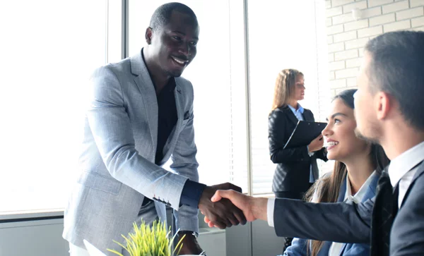 African American black man in a suit shaking hands during a job interview