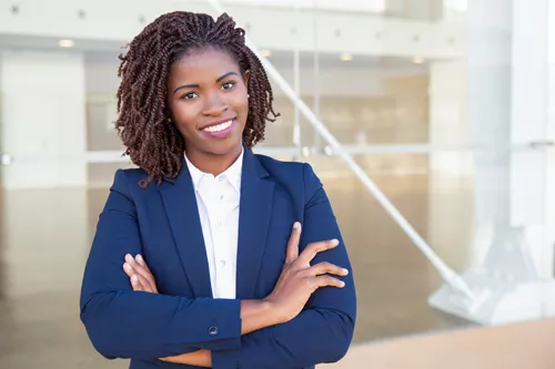 Young confident African American black woman in a suit smiling
