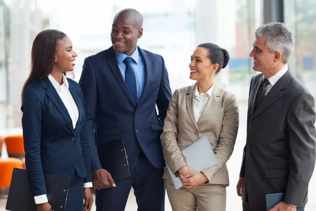A group of African American men and women and other suited business people smiling