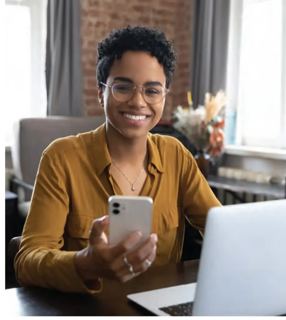 Black African American woman smiling with smartphone in hand