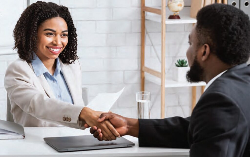 hiring manager shaking hands with new hire