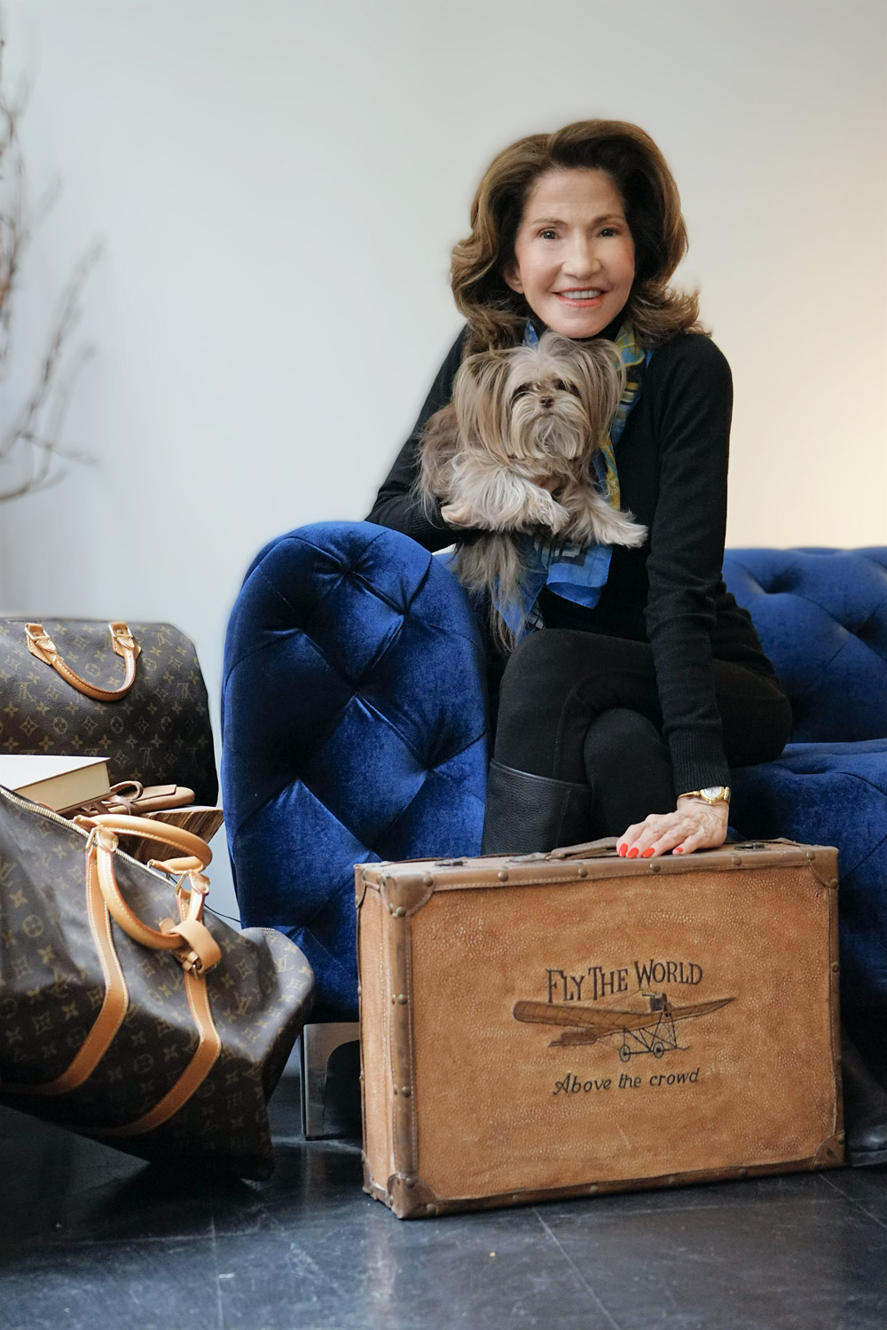 Gayle Martz sitting with a Yorkie on her lap and a Sherpa Bag beside them
