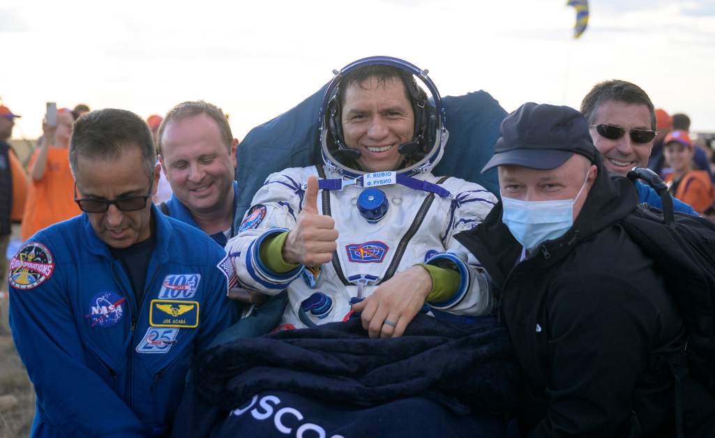 Astronaut Frank Rubio being held up by NASA staff giving the thumbs up
