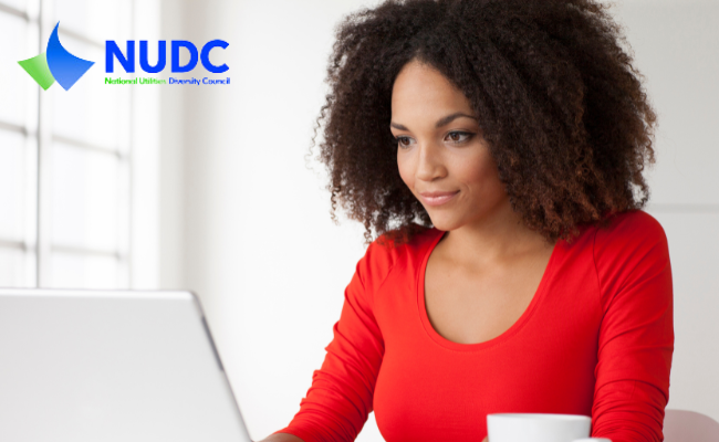 woman looking a computer screen with NUDC logo